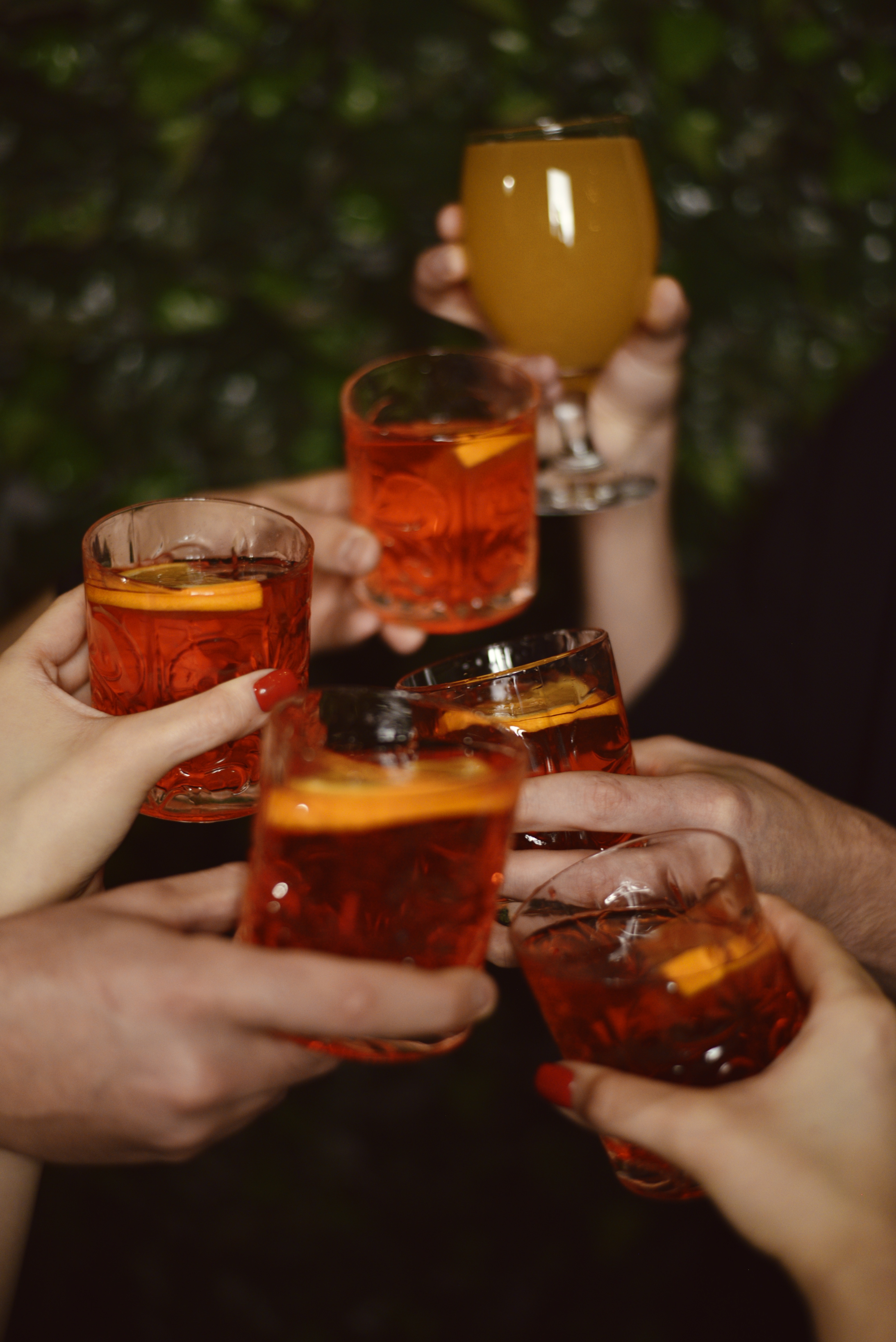 A photo of multiple people holding drinks